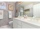 Clean bathroom with double vanity, patterned wallpaper, and updated fixtures at 24426 S Ribbonwood Dr, Sun Lakes, AZ 85248