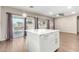 Kitchen island with white quartz countertop and white cabinets at 20293 N 83Rd Dr, Peoria, AZ 85382