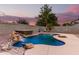 Luxury backyard oasis featuring a kidney-shaped pool and spa with a waterfall feature at 20293 N 83Rd Dr, Peoria, AZ 85382