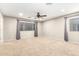 Spacious carpeted bedroom with ceiling fan and window at 20293 N 83Rd Dr, Peoria, AZ 85382
