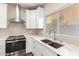 Modern kitchen with white cabinets, quartz countertops, and stainless steel appliances at 20293 N 83Rd Dr, Peoria, AZ 85382