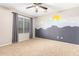Bright bedroom with mountain mural and ceiling fan at 20293 N 83Rd Dr, Peoria, AZ 85382