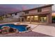 Stunning backyard with a kidney-shaped pool, spa, and covered patio at 20293 N 83Rd Dr, Peoria, AZ 85382