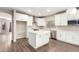 Modern kitchen with white cabinets, island, and stainless steel appliances at 20293 N 83Rd Dr, Peoria, AZ 85382