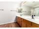 Double vanity bathroom with wood cabinets and modern fixtures at 20293 N 83Rd Dr, Peoria, AZ 85382