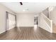 Spacious living room with wood-look floors and ceiling fan at 20293 N 83Rd Dr, Peoria, AZ 85382