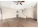 Spacious living room with wood-look floors and ceiling fan at 20293 N 83Rd Dr, Peoria, AZ 85382