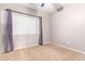 Carpeted bedroom with ceiling fan and window with blinds at 20293 N 83Rd Dr, Peoria, AZ 85382