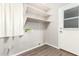 Bright laundry room with built-in shelving and exterior access at 20293 N 83Rd Dr, Peoria, AZ 85382