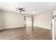 Spacious living room with wood-look floors and ceiling fan at 20293 N 83Rd Dr, Peoria, AZ 85382