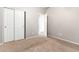 Bedroom with carpet, double door closet and door to another room at 20293 N 83Rd Dr, Peoria, AZ 85382