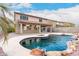 Stunning pool with a waterfall and spacious patio at 20293 N 83Rd Dr, Peoria, AZ 85382