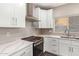 Modern kitchen with white cabinets and stainless steel appliances at 20293 N 83Rd Dr, Peoria, AZ 85382