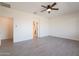 Spacious bedroom with ceiling fan and wood-look tile flooring at 22850 E Calle Luna --, Queen Creek, AZ 85142