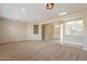 Bright and airy living room with neutral carpeting and recessed lighting at 15936 W Kino Dr, Surprise, AZ 85374