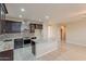 Modern kitchen with granite countertops, stainless steel appliances, and dark wood cabinetry at 15936 W Kino Dr, Surprise, AZ 85374