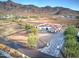 Aerial view of a single-story house with a large backyard and mountain views at 3923 W Fox Rd, Laveen, AZ 85339