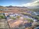 Aerial view of a single-story house with a large backyard and mountain views at 3923 W Fox Rd, Laveen, AZ 85339