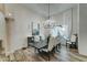 Formal dining room with a large chandelier, wood floors and view to backyard at 3923 W Fox Rd, Laveen, AZ 85339