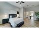 Bright bedroom with a plush bed, wood floors and an ensuite bathroom at 3923 W Fox Rd, Laveen, AZ 85339
