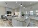 Open concept kitchen and living area with large island, fireplace and modern finishes at 3923 W Fox Rd, Laveen, AZ 85339