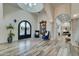 Grand entryway with high ceilings, ornate mirror, and elegant blue armchairs at 3923 W Fox Rd, Laveen, AZ 85339