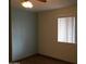 Bedroom with light blue accent wall and wood-look flooring at 144 W Peretz Cir, Morristown, AZ 85342