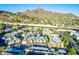 Aerial view of an apartment complex nestled in a mountain setting with ample parking at 1880 E Morten Ave # 242, Phoenix, AZ 85020