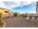 Spacious backyard with gravel, hot tub, patio furniture, and mature plants at 7577 S Towel Creek Dr, Gold Canyon, AZ 85118