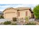 Tan house with two-car garage and landscaping at 7577 S Towel Creek Dr, Gold Canyon, AZ 85118