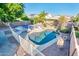 Inviting backyard oasis featuring a sparkling pool, basketball court, and ample patio space at 9016 W Tony Ct, Peoria, AZ 85382