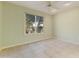 Light green bedroom with tile floors and a view of the backyard at 19562 N Wikieup Ct, Surprise, AZ 85374