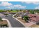 Aerial view of a residential community with houses and a golf course at 19562 N Wikieup Ct, Surprise, AZ 85374