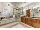 Elegant bathroom with double vanities and a walk-in shower at 19562 N Wikieup Ct, Surprise, AZ 85374