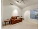 Bright sitting room featuring a brown leather sofa and tile floors at 19562 N Wikieup Ct, Surprise, AZ 85374