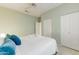 Primary bedroom with double doors and plush bedding at 19562 N Wikieup Ct, Surprise, AZ 85374