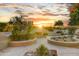 Landscaped backyard with seating and sunset view at 19562 N Wikieup Ct, Surprise, AZ 85374