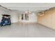 Spacious garage with storage cabinets and golf cart at 19562 N Wikieup Ct, Surprise, AZ 85374