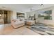 Bright Gathering room with sectional sofa and large windows at 19562 N Wikieup Ct, Surprise, AZ 85374