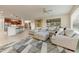 Open living room and kitchen with island and seating at 19562 N Wikieup Ct, Surprise, AZ 85374