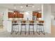 Modern kitchen island with four sleek barstools at 19562 N Wikieup Ct, Surprise, AZ 85374