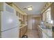 Kitchen features wood cabinets, tile flooring, and white appliances at 260 S 72Nd Pl, Mesa, AZ 85208
