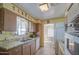 Kitchen with wood cabinets, white appliances, and a view into dining area at 260 S 72Nd Pl, Mesa, AZ 85208