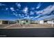 Green mobile home with carport, gravel driveway, and mature palm tree at 260 S 72Nd Pl, Mesa, AZ 85208