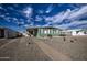 Mobile home exterior with a walkway, gravel landscaping, and partial view of neighboring homes at 260 S 72Nd Pl, Mesa, AZ 85208