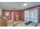 Bedroom with a queen bed, dresser, and access to a patio at 260 S 72Nd Pl, Mesa, AZ 85208