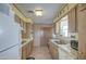 Kitchen features wood cabinets, tile flooring, and white appliances at 260 S 72Nd Pl, Mesa, AZ 85208