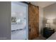 Primary bathroom with double vanity and a barn door at 7086 E Whispering Mesquite Trl, Scottsdale, AZ 85266