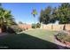 Nice backyard with grass, plants, and a fire pit at 14586 W Columbus Ave, Goodyear, AZ 85395