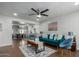 Bright living room featuring a teal sofa, wood floors, and a view to the dining area at 2518 E Campbell Ave, Phoenix, AZ 85016